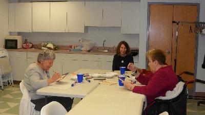 Loved ones create mosaics while their caregivers listen to Dr. Barry Jacobs, Psy.D.