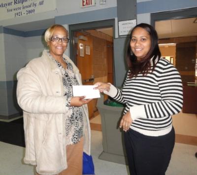 Christy Bobo (right), Housing Director at COSA, presents raffle winner Yvette Cauthorn (left), of Chester a voucher to be used for home heating oil this winter.