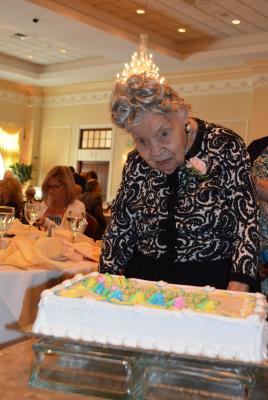 Marion Roth, of White Horse Village in Newtown Square, age 107, cuts the ceremonial birthday cake. Ms. Roth was the oldest celebrant in attendance. 
