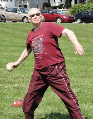 Tom Rice hurls the softball in Track and Field's softball throw.
