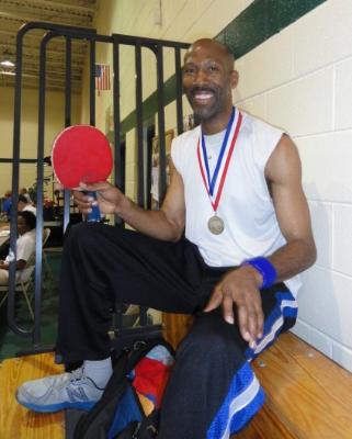 Dwan Hunt with his gold medal in Men's Singles Table Tennis. 