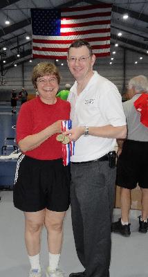 Linda Zappacosta, of Chester, is presented her gold medal in Women's Basketball by Stephen Gamble, co-chair of the Delaware County Senior Games. 