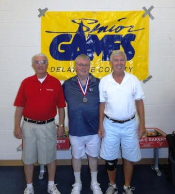 Bob Ballantine, Senior Games commitee member;J.Gym McKeone, of Media with his silver medal in Men's Singles Pickleball; and Burr Daly, Senior Games committee member.