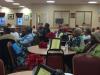 Caregivers listen to the presentation on "Understanding Fraud and other Common Preventable Concerns and Misconceptions."
