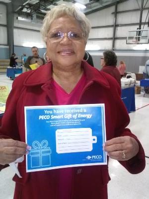Barbara Johnson, of Upper Chichester, displays her prize-a $125 PECO voucher to be used toward utility payment.